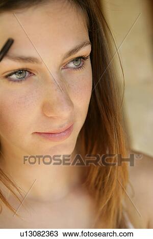 Woman combing her eyebrow. View Large Photo Image Stock Image - Woman combing her eyebrow.. Fotosearch