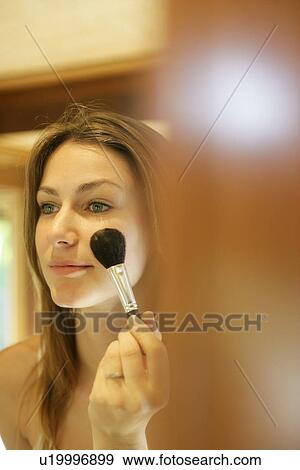 Stock Photo - Woman doing makeup.. Fotosearch