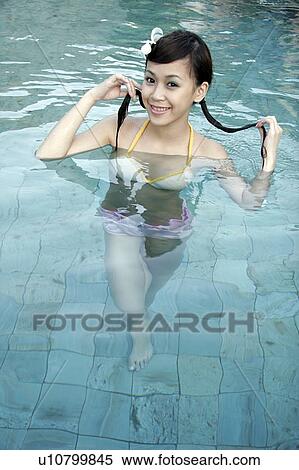 High angle view of a teenage girl holding her braids in a swimming pool. View Large Photo Image Stock Photography - High angle view of a teenage girl holding her braids in a swimming pool.. Fotosearch