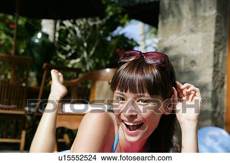 Portrait of a teenage girl laughing in the garden. View Large Photo Image Picture - Portrait of a teenage girl laughing in the garden.. Fotosearch