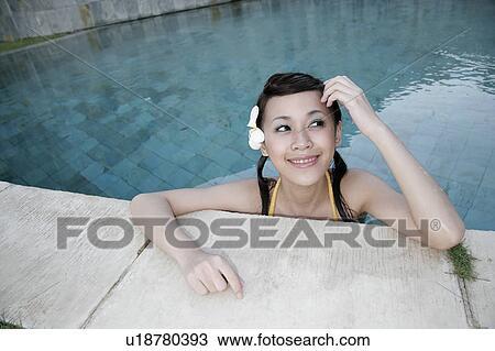 Portrait of a teenage girl leaning by a swimming pool. View Large Photo Image Stock Image - Portrait of a teenage girl leaning by a swimming pool.. Fotosearch
