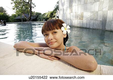 Portrait of a teenage girl leaning by a swimming pool. View Large Photo Image Stock Image - Portrait of a teenage girl leaning by a swimming pool.. Fotosearch