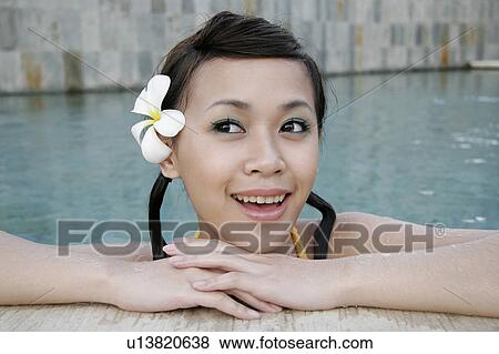 Portrait of a teenage girl leaning by a swimming pool. View Large Photo Image Stock Photo - Portrait of a teenage girl leaning by a swimming pool.. Fotosearch