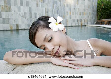 Portrait of a teenage girl leaning near swimming pool with eyes closed. View Large Photo Image Stock Image - Portrait of a teenage girl leaning near swimming pool with eyes closed.. Fotosearch