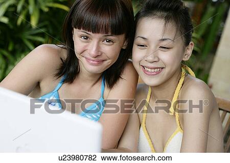 Portrait of two teenage girls wearing bikinis. View Large Photo Image Stock Image - Portrait of two teenage girls wearing bikinis.. Fotosearch