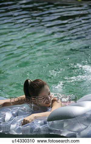 View of a teenage girl in a swimming pool. View Large Photo Image Stock Image - View of a teenage girl in a swimming pool.. Fotosearch