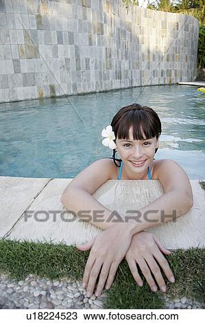Stock Image - View of a teenage girl in a swimming pool.. Fotosearch