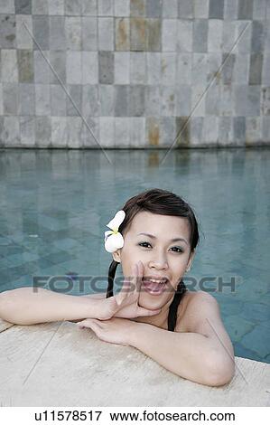 Stock Photo - View of a teenage girl in a swimming pool.. Fotosearch
