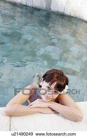 View of a teenage girl leaning by a swimming pool. View Large Photo Image Stock Photo - View of a teenage girl leaning by a swimming pool.. Fotosearch