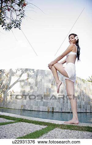 View of a teenage girl posing by a swimming pool. View Large Photo Image Stock Photograph - View of a teenage girl posing by a swimming pool.. Fotosearch