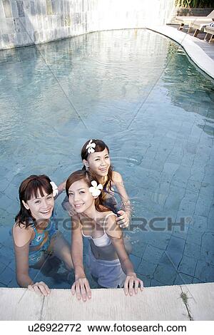 Stock Image - View of teenage girls in a swimming pool.. Fotosearch