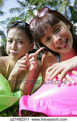 View of two teenage girls lying on grass. View Large Photo Image Stock Image - View of two teenage girls lying on grass.. Fotosearch