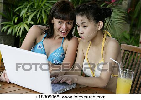 View of two teenage girls working on a laptop. View Large Photo Image Stock Photography - View of two teenage girls working on a laptop.. Fotosearch