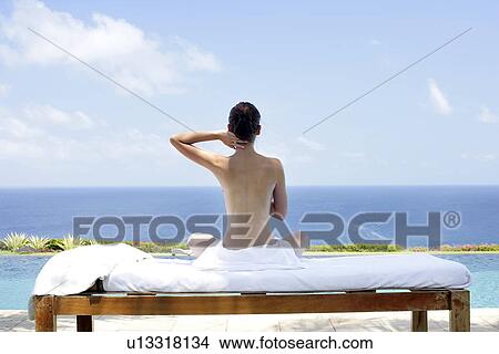 Rear view of teenage girl sun bathing. View Large Photo Image Picture - Rear view of teenage girl sun bathing.. Fotosearch