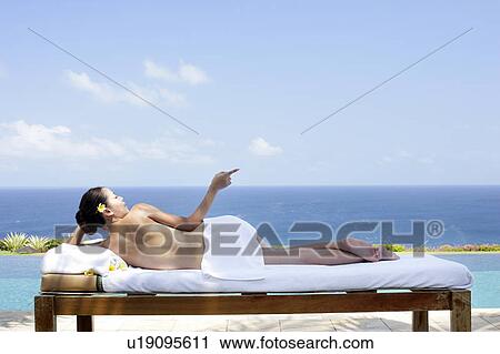 Rear view of teenage girl sun bathing. View Large Photo Image Stock Image - Rear view of teenage girl sun bathing.. Fotosearch