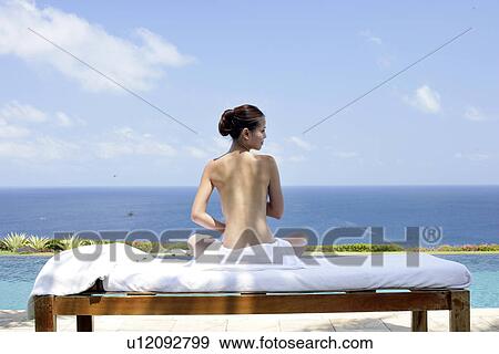 Rear view of teenage girl sun bathing. View Large Photo Image Stock Photo - Rear view of teenage girl sun bathing.. Fotosearch