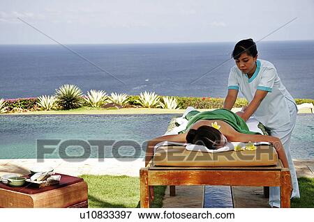 View of a female having massage by a masseuse. View Large Photo Image Stock Photo - View of a female having massage by a masseuse.. Fotosearch