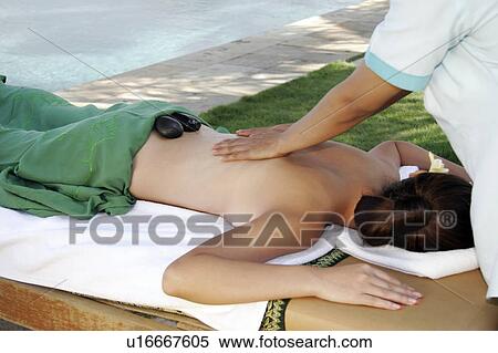 View of a female lying on a massage table. View Large Photo Image Stock Photography - View of a female lying on a massage table.. Fotosearch