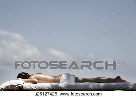 View of a female sun bathing. View Large Photo Image Stock Photograph - View of a female sun bathing.. Fotosearch