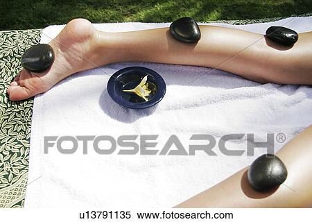View of a female undergoing a hot stone therapy. View Large Photo Image Stock Photography - View of a female undergoing a hot stone therapy.. Fotosearch
