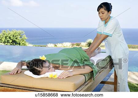 View of a masseuse massaging a teenage girl. View Large Photo Image Stock Photo - View of a masseuse massaging a teenage girl.. Fotosearch