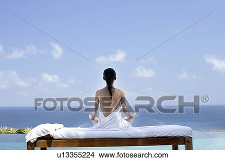 View of a seminude teenage girl in a lotus position. View Large Photo Image Picture - View of a seminude teenage girl in a lotus position.. Fotosearch