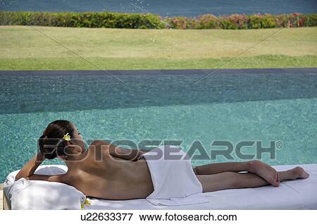 View of a seminude teenage girl lying near a swimming pool. View Large Photo Image Stock Photo - View of a seminude teenage girl lying near a swimming pool.. Fotosearch