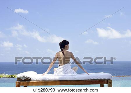 View of a seminude teenage girl on a bed against the sea. View Large Photo Image Stock Image - View of a seminude teenage girl on a bed against the sea.. Fotosearch