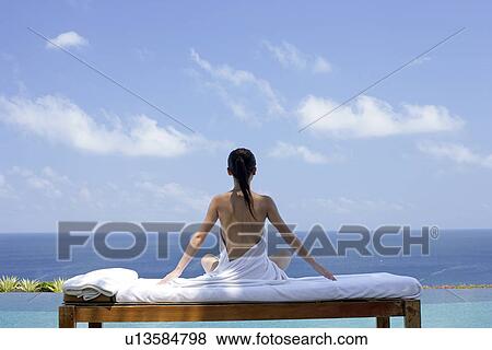 View of a seminude teenage girl on a bed against the sea. View Large Photo Image Stock Photo - View of a seminude teenage girl on a bed against the sea.. Fotosearch