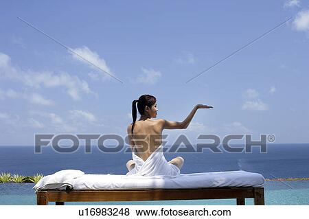 View of a seminude teenage girl on a bed against the sea. View Large Photo Image Stock Photo - View of a seminude teenage girl on a bed against the sea.. Fotosearch