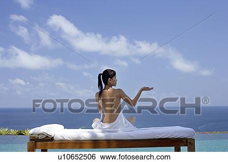 View of a seminude teenage girl on a bed against the sea. View Large Photo Image Stock Photograph - View of a seminude teenage girl on a bed against the sea.. Fotosearch