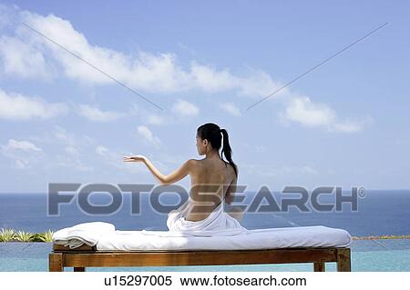View of a seminude teenage girl on a bed against the sea. View Large Photo Image Stock Photography - View of a seminude teenage girl on a bed against the sea.. Fotosearch