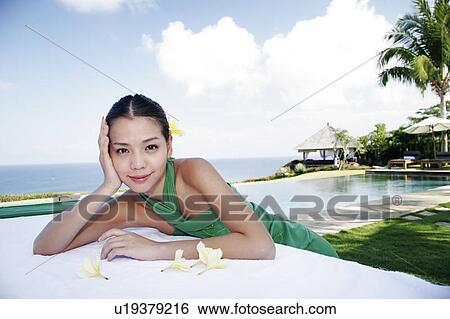 View of a teenage girl leaning on a table. View Large Photo Image Stock Photograph - View of a teenage girl leaning on a table.. Fotosearch