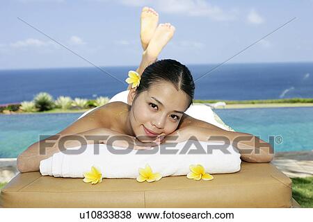 Stock Photo - View of a teenage girl lying on a massage table.. Fotosearch