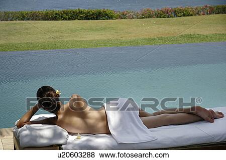 View of a teenage girl lying on a massage table. View Large Photo Image Stock Photo - View of a teenage girl lying on a massage table.. Fotosearch