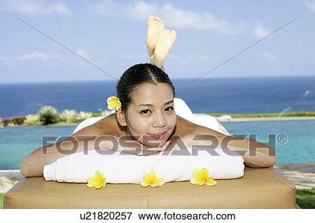 View of a teenage girl lying on a massage table. View Large Photo Image Stock Photo - View of a teenage girl lying on a massage table.. Fotosearch