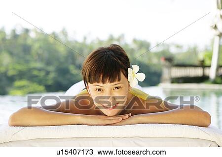 View of a teenage girl relaxing on a bed. View Large Photo Image Stock Image - View of a teenage girl relaxing on a bed.. Fotosearch