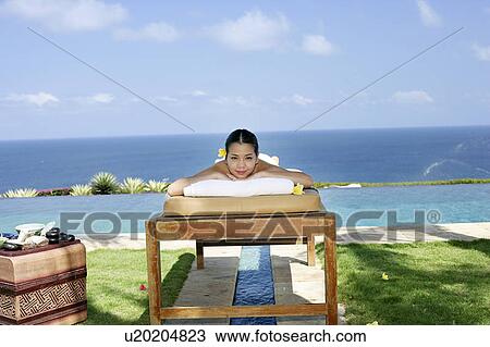 View of a teenage girl relaxing on a bed. View Large Photo Image Stock Image - View of a teenage girl relaxing on a bed.. Fotosearch