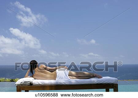 View of a teenage girl relaxing on a bed against the sea. View Large Photo Image Stock Photo - View of a teenage girl relaxing on a bed against the sea.. Fotosearch