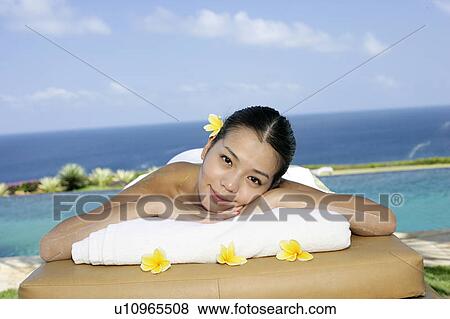 View of a teenage girl relaxing on a bed. View Large Photo Image Stock Photo - View of a teenage girl relaxing on a bed.. Fotosearch
