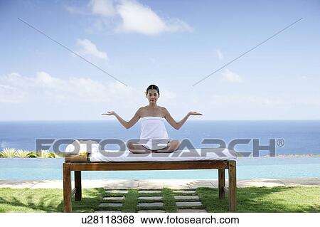 View of a teenage girl sitting on a bed. View Large Photo Image Stock Photo - View of a teenage girl sitting on a bed.. Fotosearch