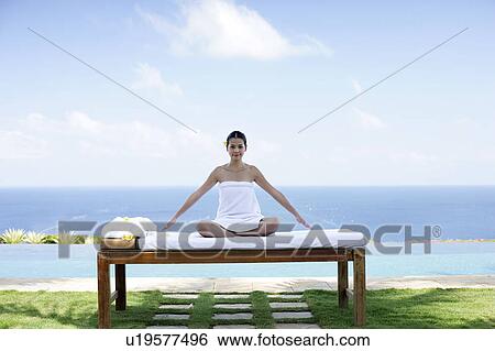 View of a teenage girl sitting on a bed. View Large Photo Image Stock Photograph - View of a teenage girl sitting on a bed.. Fotosearch