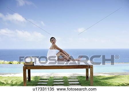 View of a teenage girl sitting on a bed. View Large Photo Image Stock Photography - View of a teenage girl sitting on a bed.. Fotosearch