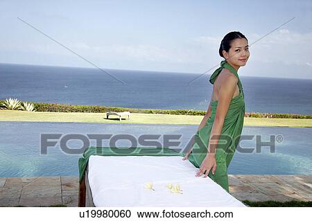 View of a teenage girl standing near the sea. View Large Photo Image Stock Image - View of a teenage girl standing near the sea.. Fotosearch