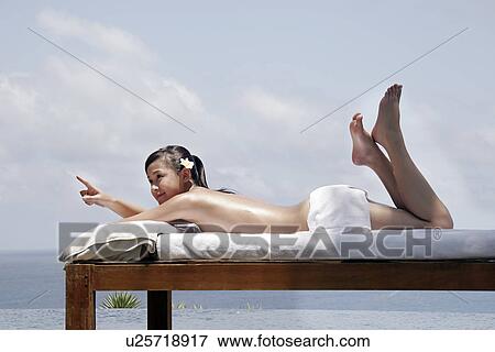 Stock Photo - View of a teenage girl sun bathing.. Fotosearch