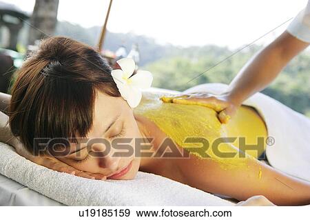 Stock Photo - View of a teenage girl taking a spa treatment.. Fotosearch