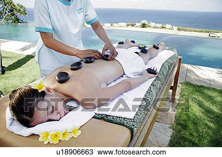 View of a teenage girl undergoing a hot stone therapy. View Large Photo Image Stock Image - View of a teenage girl undergoing a hot stone therapy.. Fotosearch