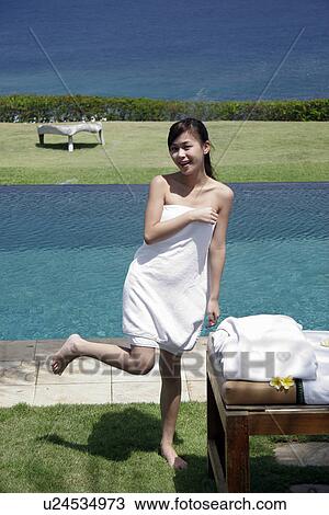 A teenage girl standing near a swimming pool. View Large Photo Image Stock Image - A teenage girl standing near a swimming pool.. Fotosearch