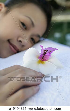 Close-up of a teenage girl holding a flower. View Large Photo Image Stock Photography - Close-up of a teenage girl holding a flower.. Fotosearch