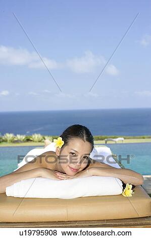Portrait of a teenage girl lying on a bed. View Large Photo Image Stock Photo - Portrait of a teenage girl lying on a bed.. Fotosearch
